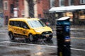 Yellow taxi speeding through the snow storm with motion bluer