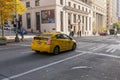 Yellow taxi stopped at a traffic light on downtown Seattle Street, Washington, USA.