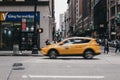 Yellow taxi on the street in New York, motion blurred. Royalty Free Stock Photo