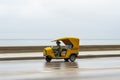 HAVANA, CUBA - OCTOBER 21, 2017: Yellow Taxi Tuk Tuk Vehicle in Havana, Cuba Royalty Free Stock Photo