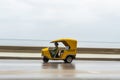 HAVANA, CUBA - OCTOBER 21, 2017: Yellow Taxi Tuk Tuk Vehicle in Havana, Cuba. Woman Driver Royalty Free Stock Photo