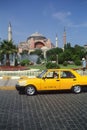 Yellow taxi waits outside Hagai Sofia. Istanbul, T