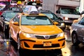 Yellow taxy cab in wet ny street. Royalty Free Stock Photo