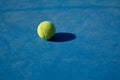 yellow tennis ball on a blue court Royalty Free Stock Photo