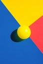 Yellow tennis ball on blue red polygon shape elements. Abstract colorful graphic geometric composition. Business innovation