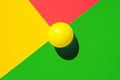 Yellow tennis ball on green red triangle intersection. Abstract colorful graphic geometric background. Business innovation