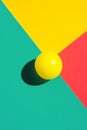 Yellow tennis ball on turquoise red triangle elements. Abstract colorful graphic geometric composition. Business innovation