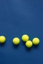 Yellow tennis balls on blue background flat lay. Color of the year 2020, vertical format photo. Active lifestyle concept. Sports