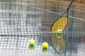 Yellow tennis balls on hard court in raining weather Royalty Free Stock Photo