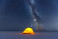 Yellow tent lighted from the inside against the backdrop of starry sky Royalty Free Stock Photo