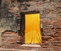 A yellow textile fabric hangs