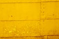 Yellow textural background of old rusty metal sheets fastened together with rivets and nails Royalty Free Stock Photo