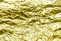 Yellow texture of crumpled sheet of aluminum foil. Foil background. Royalty Free Stock Photo