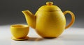 Yellow Textured Teapot and Cup Set on White Surface Royalty Free Stock Photo