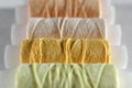 Yellow thread. Several coils of thread in different shades of yellow, beige and light green.