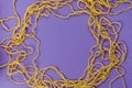 Yellow threads for creativity on a purple background Royalty Free Stock Photo