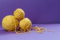 Yellow threads for creativity on a purple background Royalty Free Stock Photo