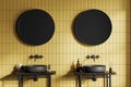 Yellow tile bathroom interior with double sink and round mirrors