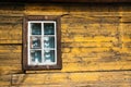 Yellow timbered wooden wall with white window Royalty Free Stock Photo