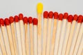 Yellow tipped match with red tipped matches Royalty Free Stock Photo