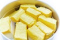 The yellow tofu in a basket filled with water. isolated white background Royalty Free Stock Photo