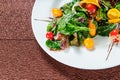 Yellow tomato, cucumber, red cabbage and watermelon radish vegetables salad. healthy raw vegan food. Top view Royalty Free Stock Photo