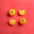Yellow tomatoes on red background, flat lay Royalty Free Stock Photo