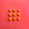 Yellow tomatoes on red background, flat lay Royalty Free Stock Photo