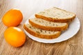 Yellow tomatoes, plate of slices of bread with cereals on wooden table Royalty Free Stock Photo