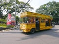 Yellow Tour Bus in Jl. Martadinata in Bandung, Indonesia Royalty Free Stock Photo