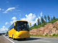 Yellow tourist bus on country highway Royalty Free Stock Photo