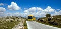 Yellow tourist bus in nature reserve El Torcal