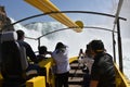 Yellow tourist ship approaching Rhine Falls waterfall to experience splashing white water.