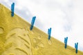 Yellow towel hanging outside on a washing line Royalty Free Stock Photo