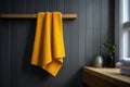 Yellow towel hanging on wooden rail in modern bathroom Royalty Free Stock Photo