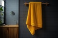 Yellow towel hanging on wooden rail in modern bathroom Royalty Free Stock Photo