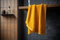 Yellow towel hanging on wooden rail in modern bathroom Royalty Free Stock Photo