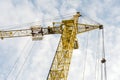 Yellow tower crane on a background of blue sky with clouds, industry abstract background Royalty Free Stock Photo