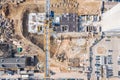 Yellow tower crane at city construction site. aerial top view Royalty Free Stock Photo