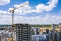 Yellow tower crane on the construction of new residential building against the blue sky. aerial photo Royalty Free Stock Photo