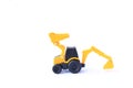 The yellow toy car Bulldozer-Excavator isolated on white background. Children`s backhoe toy model