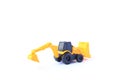 The yellow toy car Bulldozer-Excavator isolated on white background. Children`s backhoe toy model