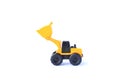 The yellow toy car Bulldozer isolated on white background. Children`s tractor toy. Wheel loader construction car model Royalty Free Stock Photo