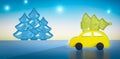 Yellow toy car with a christmas tree on the roof on night sky background.