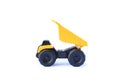 The yellow toy car Heavy truck isolated on white background. Children`s tractor toy. Wheel loader construction car model Royalty Free Stock Photo