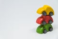 Yellow toy car and red toy car overlay on green toy car with white background and selective focus Royalty Free Stock Photo