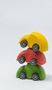 Yellow toy car and red toy car overlay on green toy car with white background and selective focus Royalty Free Stock Photo