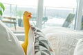Yellow dinosaur in parent bed, depicting parenting lifestyle and a real home