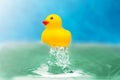 Yellow toy duckling in blue wather Royalty Free Stock Photo