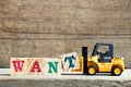 Yellow toy forklift hold letter block t to word want